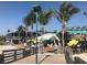 Beachfront bar with outdoor seating and palm trees at 932 Capri Isles Blvd # 216, Venice, FL 34292