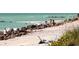 Beachfront property with rocky shoreline and people enjoying the ocean at 932 Capri Isles Blvd # 216, Venice, FL 34292