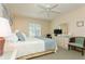 Spacious bedroom with dresser, TV and ceiling fan at 932 Capri Isles Blvd # 216, Venice, FL 34292