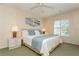 Bright bedroom with a queen-size bed and window shutters at 932 Capri Isles Blvd # 216, Venice, FL 34292