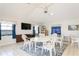 Community room with tables, chairs, TV, and game shelves at 932 Capri Isles Blvd # 216, Venice, FL 34292