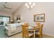 Bright dining area with wood table and four chairs, near living room at 932 Capri Isles Blvd # 216, Venice, FL 34292