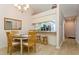Charming dining area with kitchen passthrough and four chairs at 932 Capri Isles Blvd # 216, Venice, FL 34292