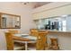 Cozy dining area with pass-through to kitchen and four chairs at 932 Capri Isles Blvd # 216, Venice, FL 34292