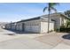 Row of attached garages with white doors and light gray building exterior at 932 Capri Isles Blvd # 216, Venice, FL 34292