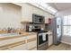 Kitchen with stainless steel appliances and wood cabinets at 932 Capri Isles Blvd # 216, Venice, FL 34292