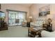 Living room with balcony access and plush seating at 932 Capri Isles Blvd # 216, Venice, FL 34292