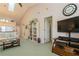 Relaxing living room with built-in shelving and a large TV at 932 Capri Isles Blvd # 216, Venice, FL 34292