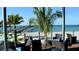 Relaxing ocean view from a patio area with palm trees at 932 Capri Isles Blvd # 216, Venice, FL 34292