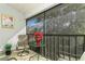 Relaxing screened balcony furnished with comfortable seating at 932 Capri Isles Blvd # 216, Venice, FL 34292