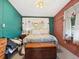 Quaint bedroom with unique walls, comfortable bed, and natural light at 1000 Dartmouth Dr, Bradenton, FL 34207