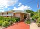 Charming community building featuring well-maintained landscaping, a walkway and American flag at 1000 Dartmouth Dr, Bradenton, FL 34207