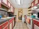 Kitchen with red and white cabinets and standard appliances at 1000 Dartmouth Dr, Bradenton, FL 34207