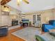 Inviting living room with fireplace, stone accent wall, hardwood floors, and comfortable seating at 1000 Dartmouth Dr, Bradenton, FL 34207
