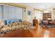 Cozy living room featuring hardwood floors, large windows, and comfortable seating at 1000 Dartmouth Dr, Bradenton, FL 34207