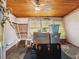 Cozy sunroom with wood-paneled ceiling, stone floor, and large windows allowing natural light at 1000 Dartmouth Dr, Bradenton, FL 34207