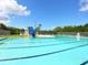 Community swimming pool with slide and lounge chairs at 1000 Dartmouth Dr, Bradenton, FL 34207