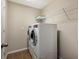 Bright laundry room with washer, dryer, and overhead shelving at 12439 Trailhead Dr, Bradenton, FL 34211