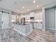 Modern kitchen with white cabinets, large island, and stainless steel appliances at 14316 Skipping Stone Loop, Parrish, FL 34219