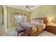 Cozy bedroom with a king-size bed and tropical decor at 1965 White Feather Ln, Nokomis, FL 34275