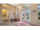Bright and spacious entryway with tiled floors and a bench at 1965 White Feather Ln, Nokomis, FL 34275