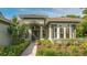 Inviting entryway with lush landscaping and columns at 1965 White Feather Ln, Nokomis, FL 34275