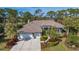 Beautiful home with tile roof, landscaping, and a 3-car garage at 1965 White Feather Ln, Nokomis, FL 34275