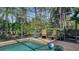 Relaxing pool area with screened enclosure, wicker chairs, and a beach ball at 1965 White Feather Ln, Nokomis, FL 34275