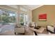 Relaxing sitting area with multiple doors leading to the pool at 1965 White Feather Ln, Nokomis, FL 34275