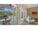 Bright sunroom with pool view, comfortable seating, and access to outdoor dining at 1965 White Feather Ln, Nokomis, FL 34275