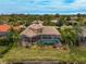 Luxury home with pool and screened lanai, offering waterfront access at 2123 Calusa Lakes Blvd, Nokomis, FL 34275