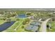 Aerial view of a golf course community with tennis courts and a clubhouse at 2123 Calusa Lakes Blvd, Nokomis, FL 34275