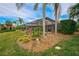 Landscaped backyard with a large screened pool enclosure at 2123 Calusa Lakes Blvd, Nokomis, FL 34275