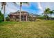 Expansive backyard with a screened pool and lush landscaping at 2123 Calusa Lakes Blvd, Nokomis, FL 34275