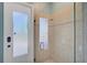 Bathroom with shower, tile surround, and frosted glass door at 2123 Calusa Lakes Blvd, Nokomis, FL 34275