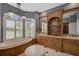 Luxurious bathroom with a large soaking tub, double vanities, and lots of natural light at 2123 Calusa Lakes Blvd, Nokomis, FL 34275