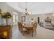 Elegant dining room featuring a large table, chandelier, and hardwood floors at 2123 Calusa Lakes Blvd, Nokomis, FL 34275