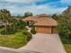 Beautiful single-Gathering home with a tile roof, two-car garage, and lush landscaping at 2123 Calusa Lakes Blvd, Nokomis, FL 34275