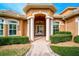 Elegant entryway with white columns and a double door entrance at 2123 Calusa Lakes Blvd, Nokomis, FL 34275