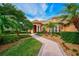 Landscaped walkway leading to the entrance of a charming house at 2123 Calusa Lakes Blvd, Nokomis, FL 34275