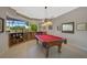 Game room with pool table and built-in bar at 2123 Calusa Lakes Blvd, Nokomis, FL 34275