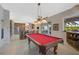 Game room with pool table and views into kitchen area at 2123 Calusa Lakes Blvd, Nokomis, FL 34275