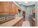Laundry room with built-in cabinets and sink at 2123 Calusa Lakes Blvd, Nokomis, FL 34275