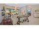 Spacious living room with a fireplace and view to the pool at 2123 Calusa Lakes Blvd, Nokomis, FL 34275