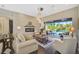 Living room with a fireplace, large windows, and a view of the pool at 2123 Calusa Lakes Blvd, Nokomis, FL 34275