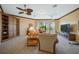 Living area with built-in shelving, balcony access, and comfortable furniture at 2123 Calusa Lakes Blvd, Nokomis, FL 34275
