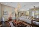 Spacious living room featuring a large chandelier and comfortable seating at 2123 Calusa Lakes Blvd, Nokomis, FL 34275