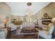 Open concept living room with hardwood floors and a view of the dining area at 2123 Calusa Lakes Blvd, Nokomis, FL 34275