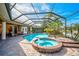 Luxury pool and spa with a screened enclosure, overlooking a golf course at 2123 Calusa Lakes Blvd, Nokomis, FL 34275