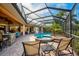Relaxing pool and spa with screened enclosure and lounge chairs at 2123 Calusa Lakes Blvd, Nokomis, FL 34275